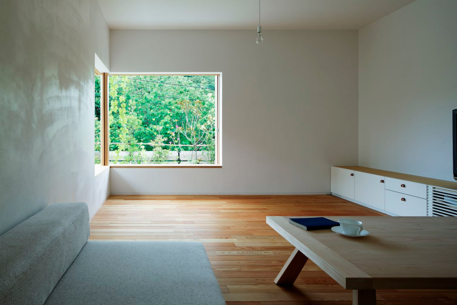 Minimalist white living room with large windows
