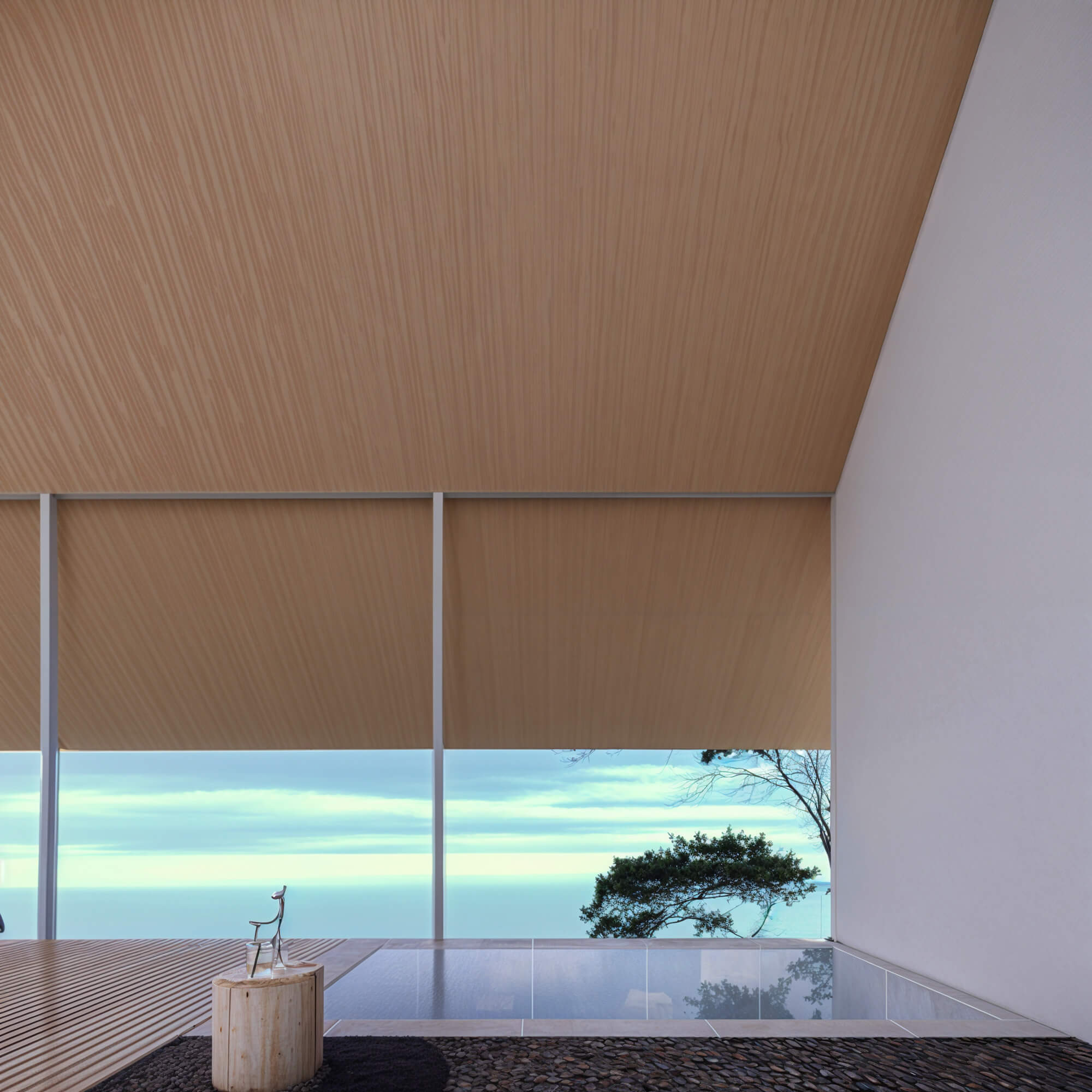 Glass-walled bathroom with a view of the ocean