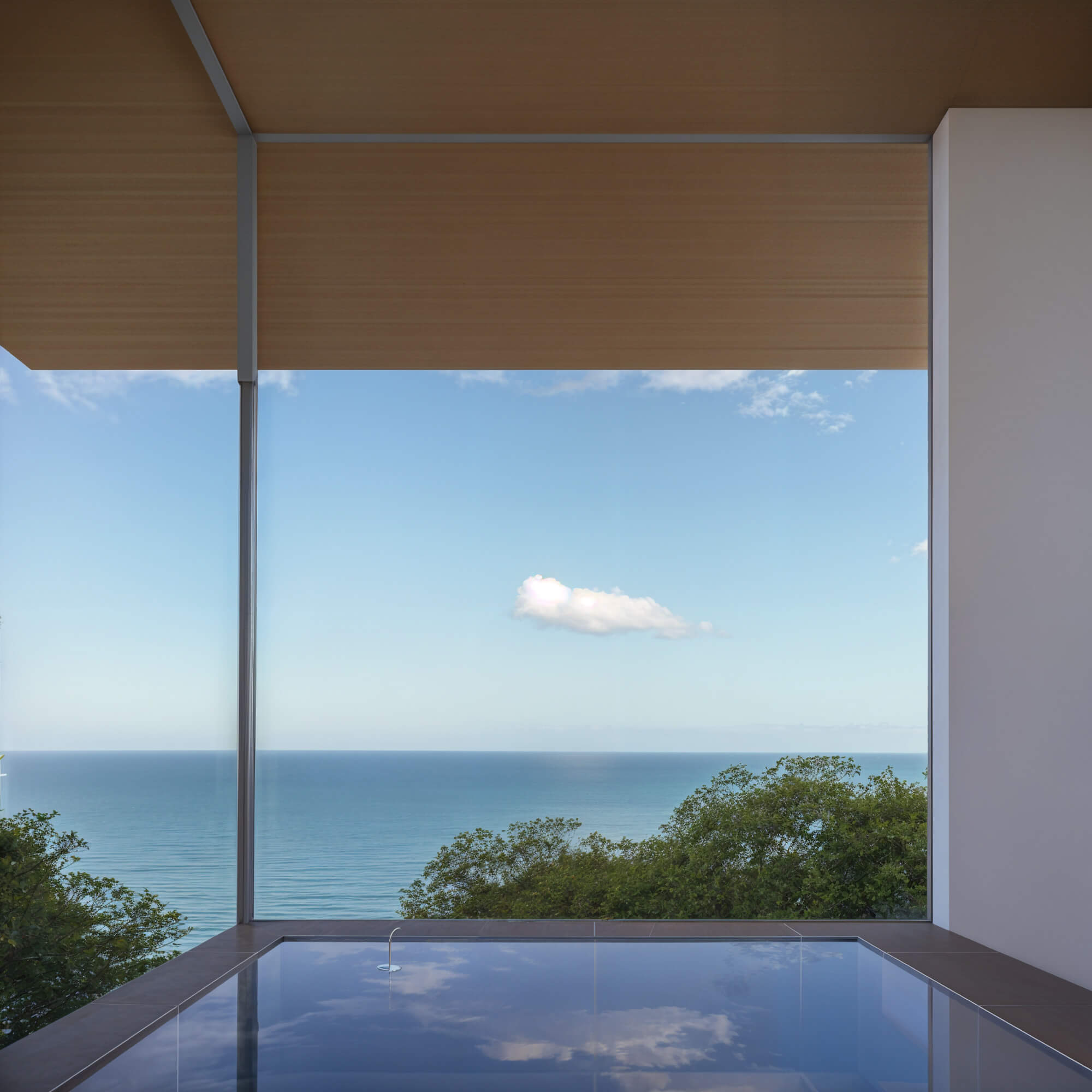 Bath designed like an infinity tub overlooking the ocean and sky
