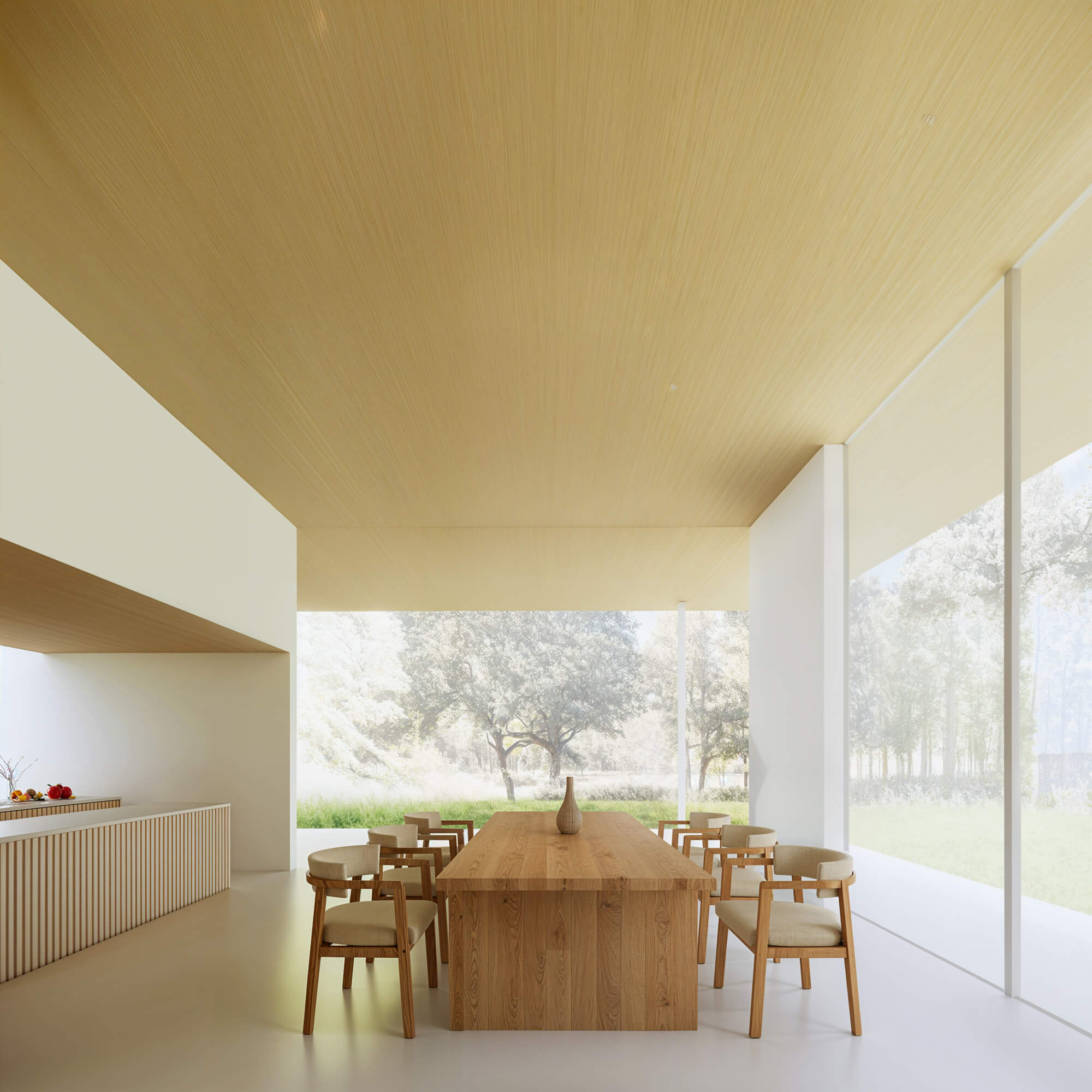 Dining space where a wooden table harmonizes with the forest view through the window