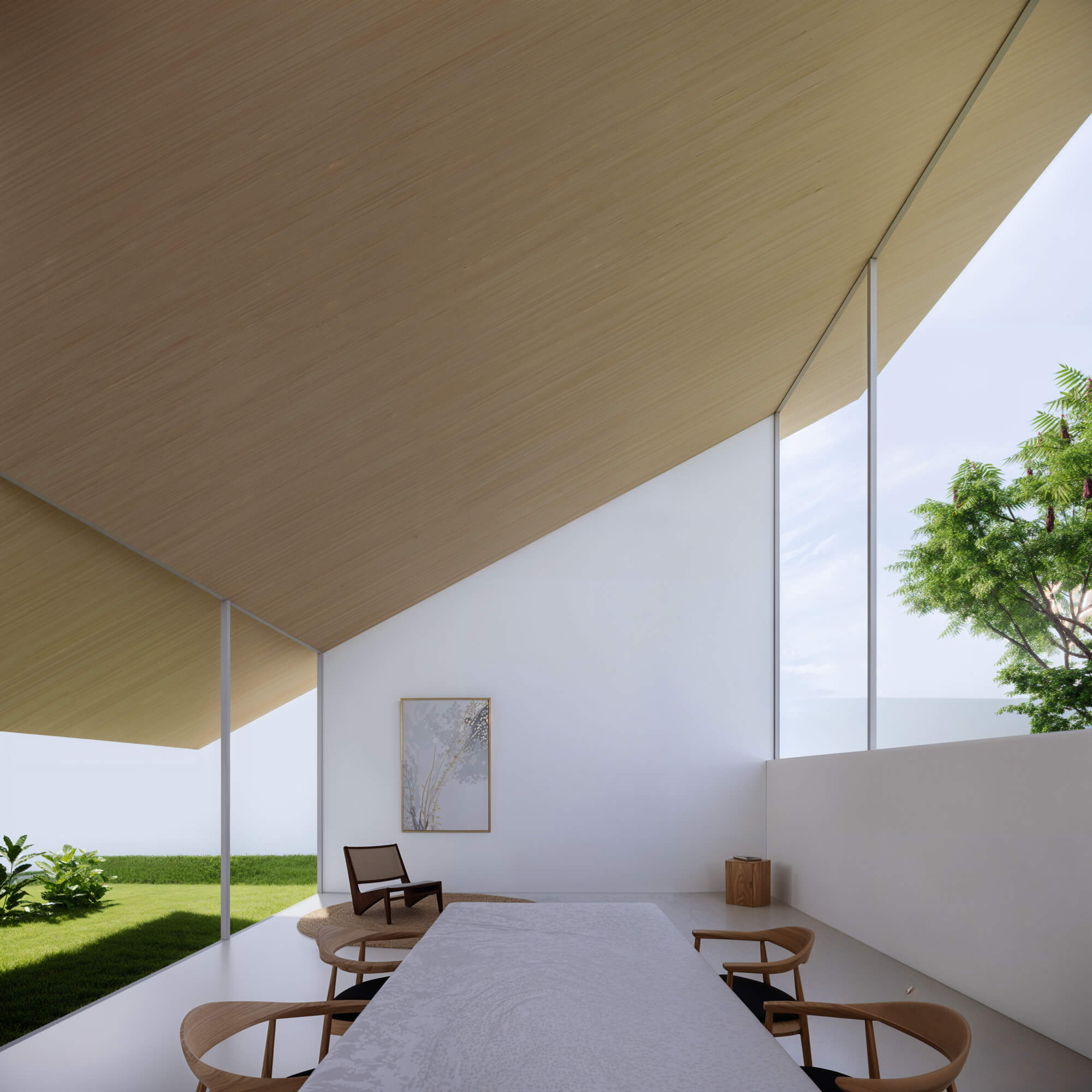 Dining area with a long table, slanted ceiling, and greenery outside
