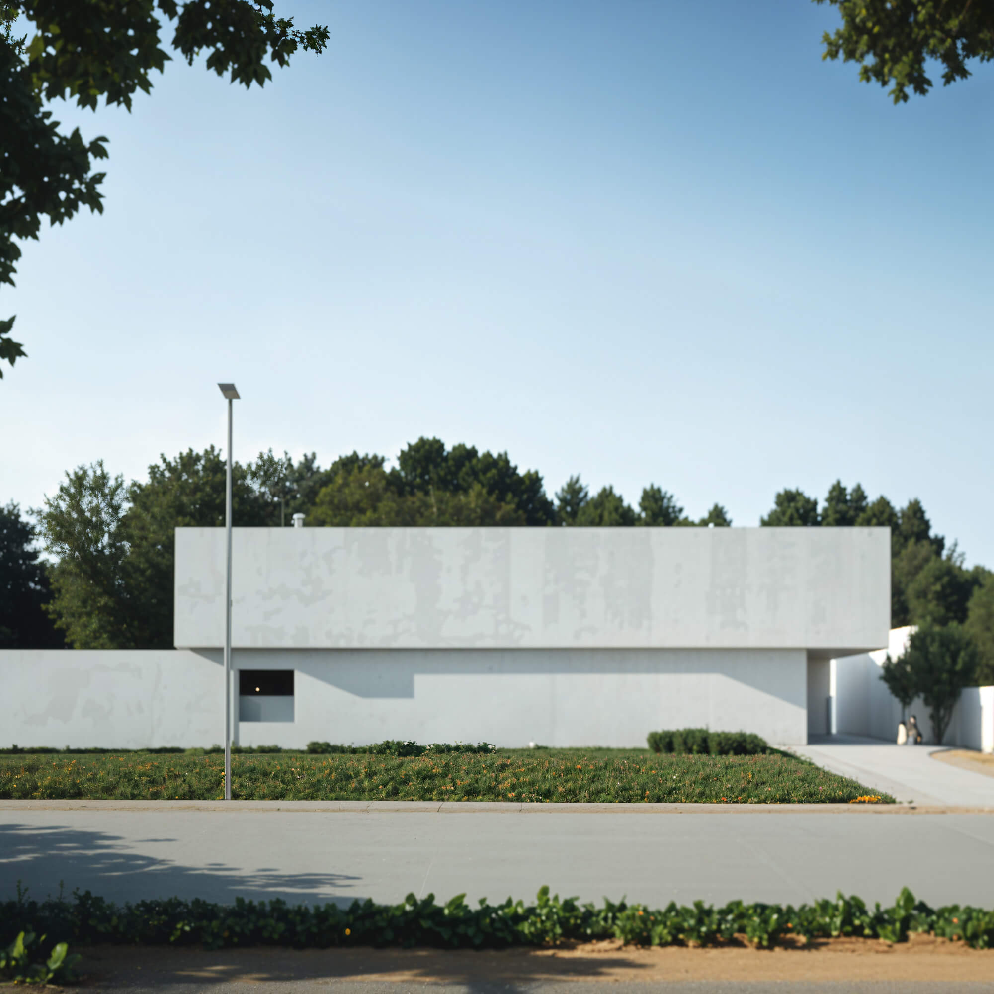 Simple white facade surrounded by trees