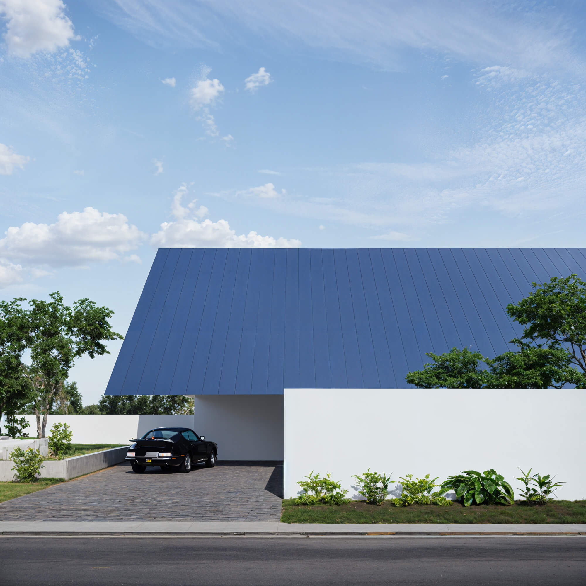 Modern facade with striking blue roof and white walls