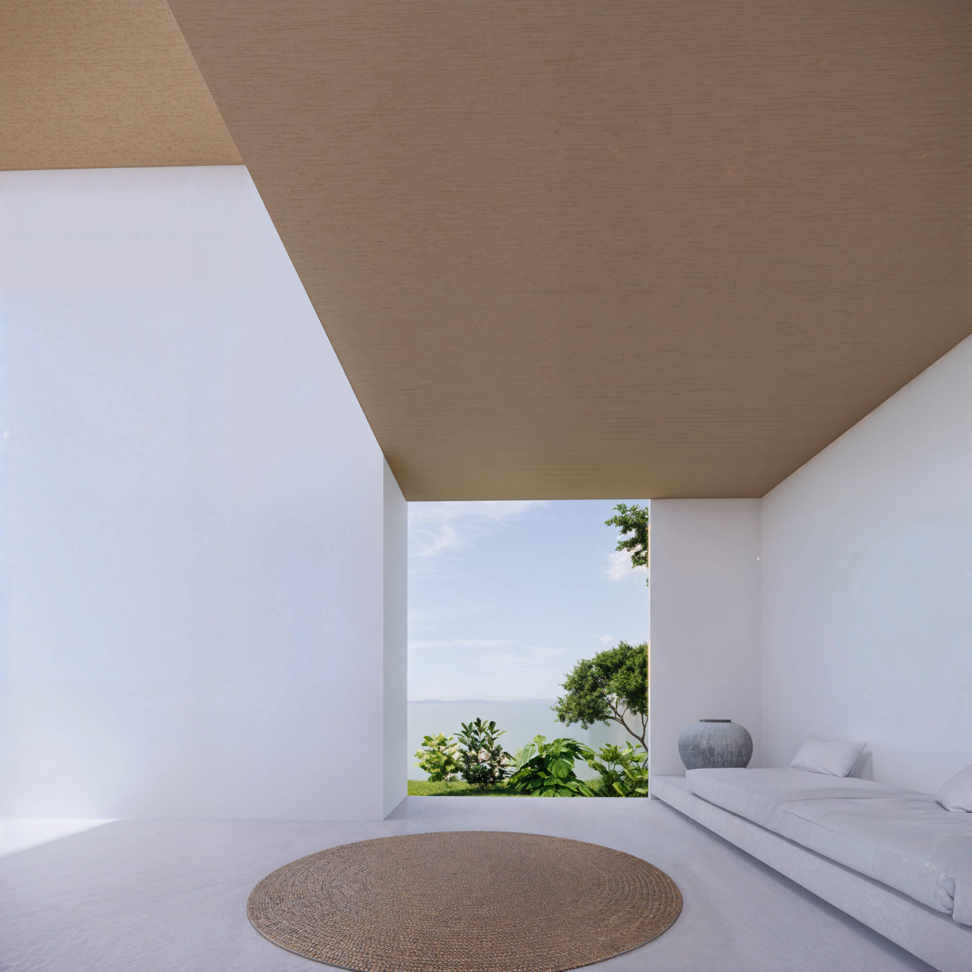 Living corner with white walls, round rug, and a view of trees through the window