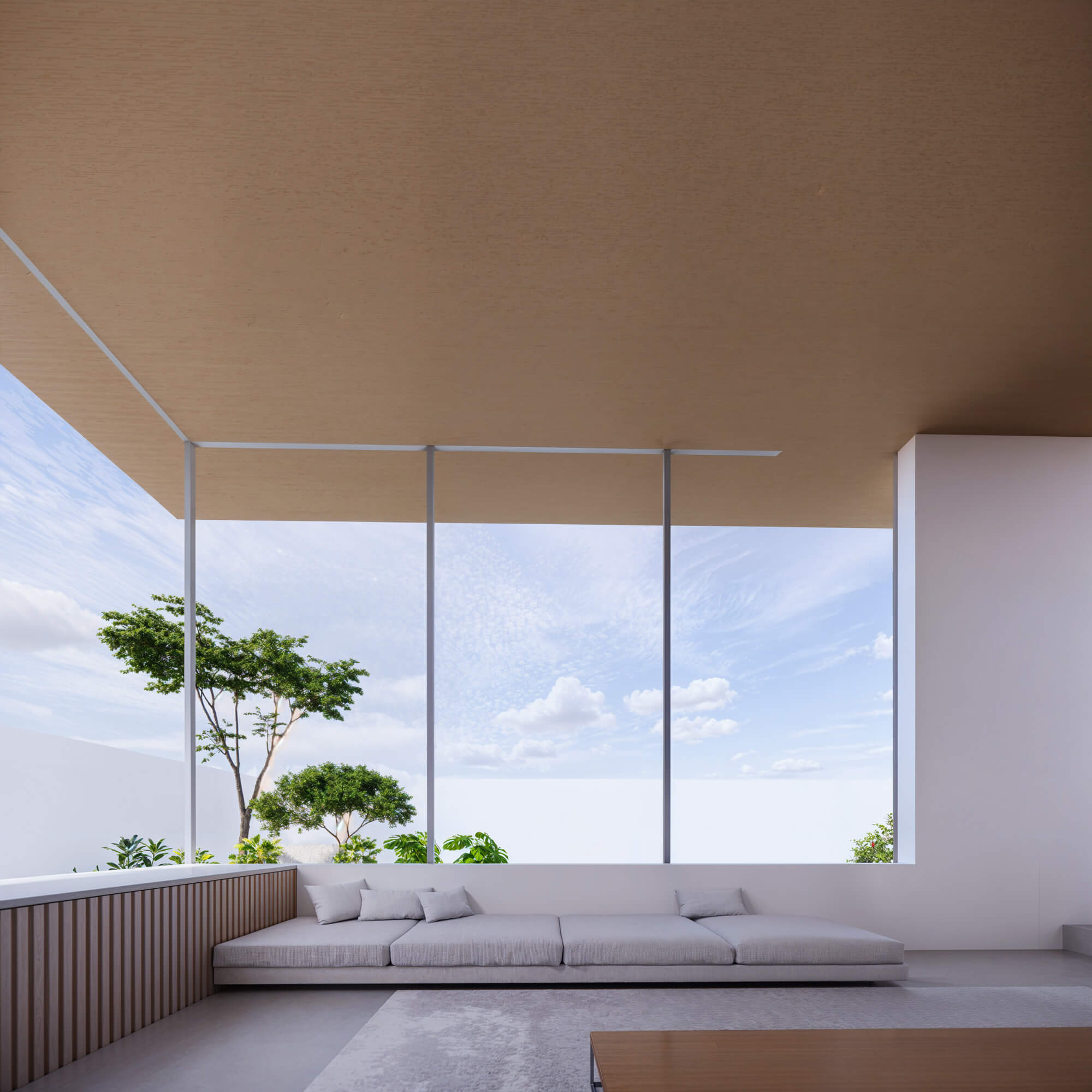 Open living space surrounded by windows with a sofa