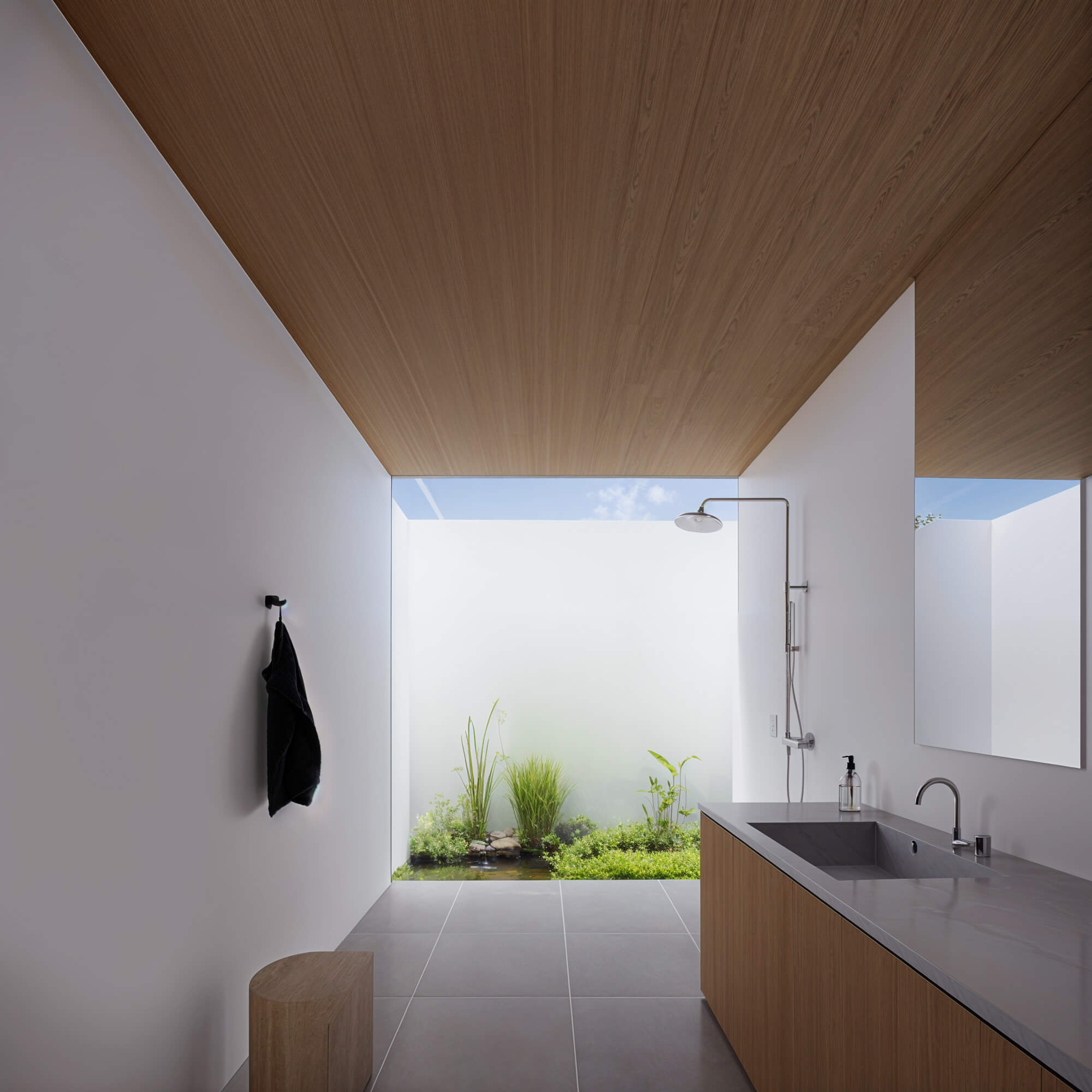 Open semi-outdoor style wash area with a view of greenery