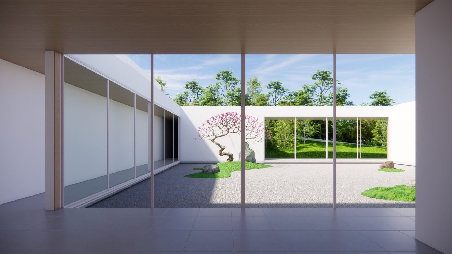 A modern space featuring large glass windows facing the courtyard, embracing nature