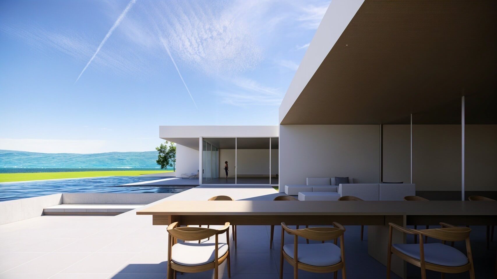 An open terrace overlooking a lake and a well-appointed dining space
